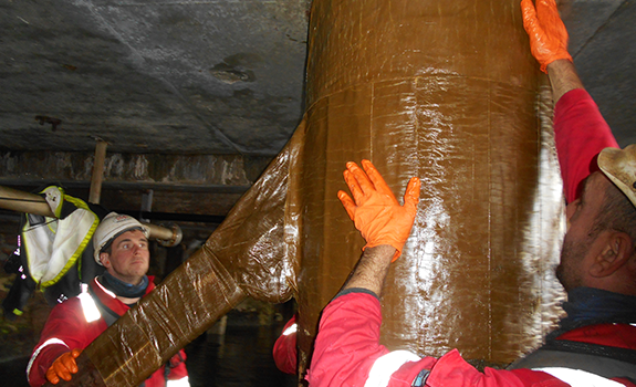 Marine piling tape applied to the jetty piles and crossbeams at Ullapool Harbour