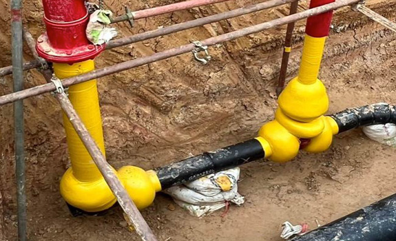 A valve in a trench protected with a petrolatum tape system.