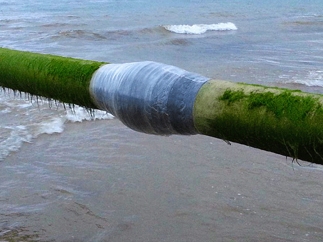 Section of partially submerged outfall pipeline protected with SeaShield 70/80 System